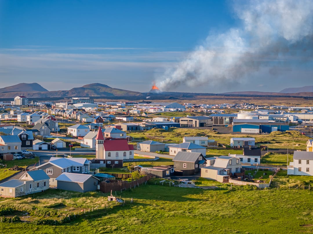 grindavík with erupting volcano in background