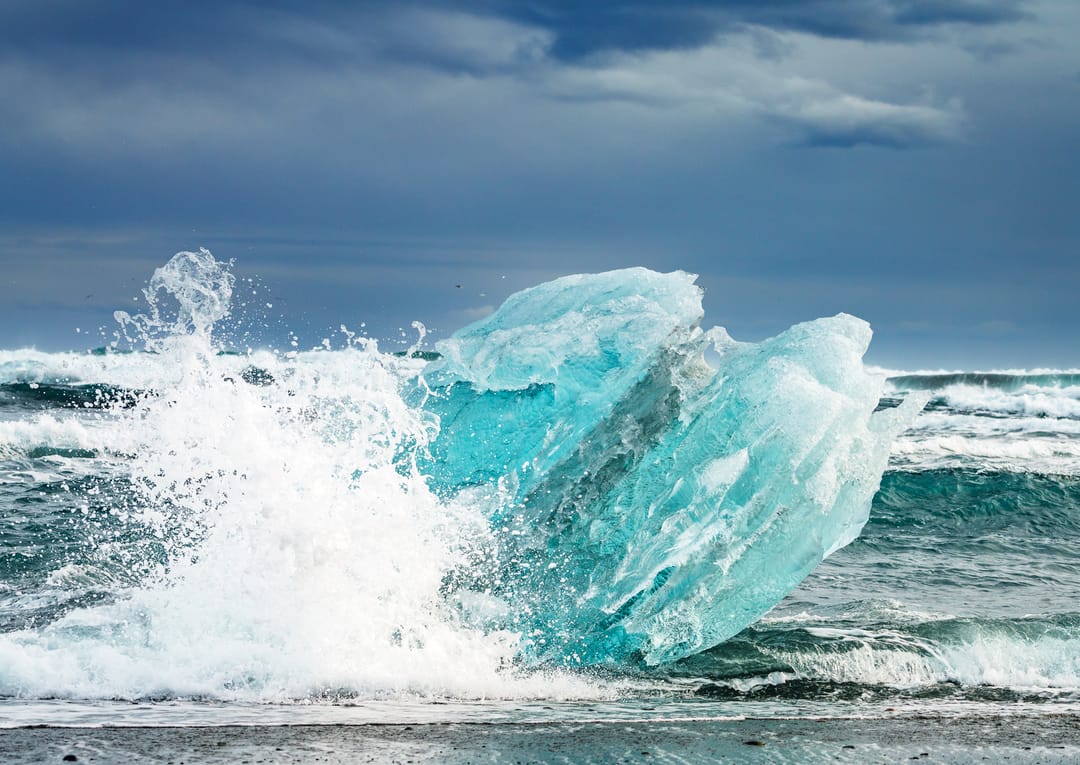 a wave crashing into icebergs
