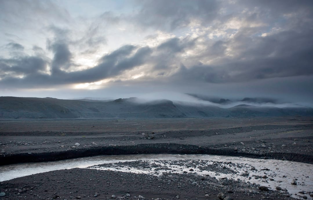 black sand with a river in sólheimasandur
