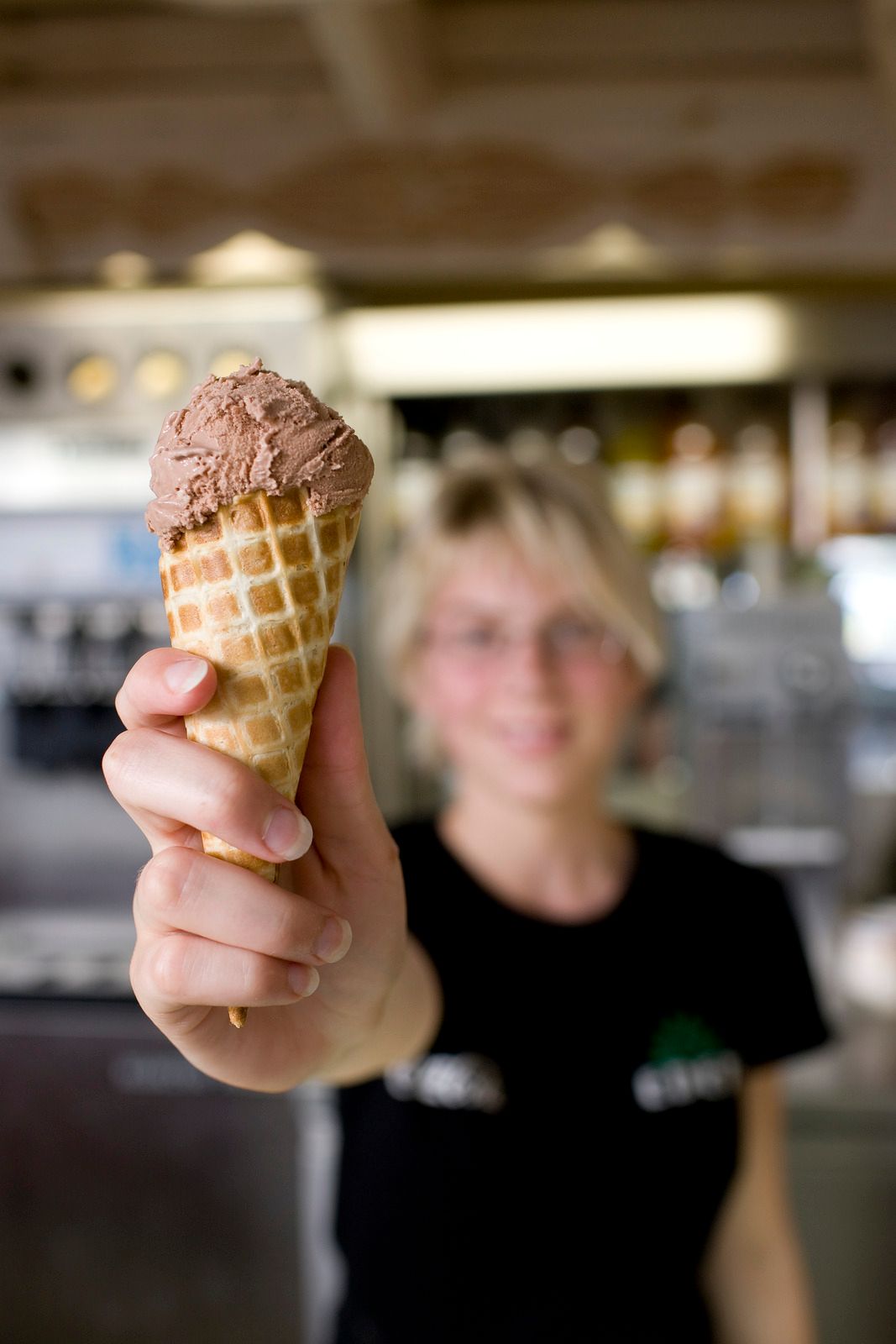 Woman handing over chocolate icecream