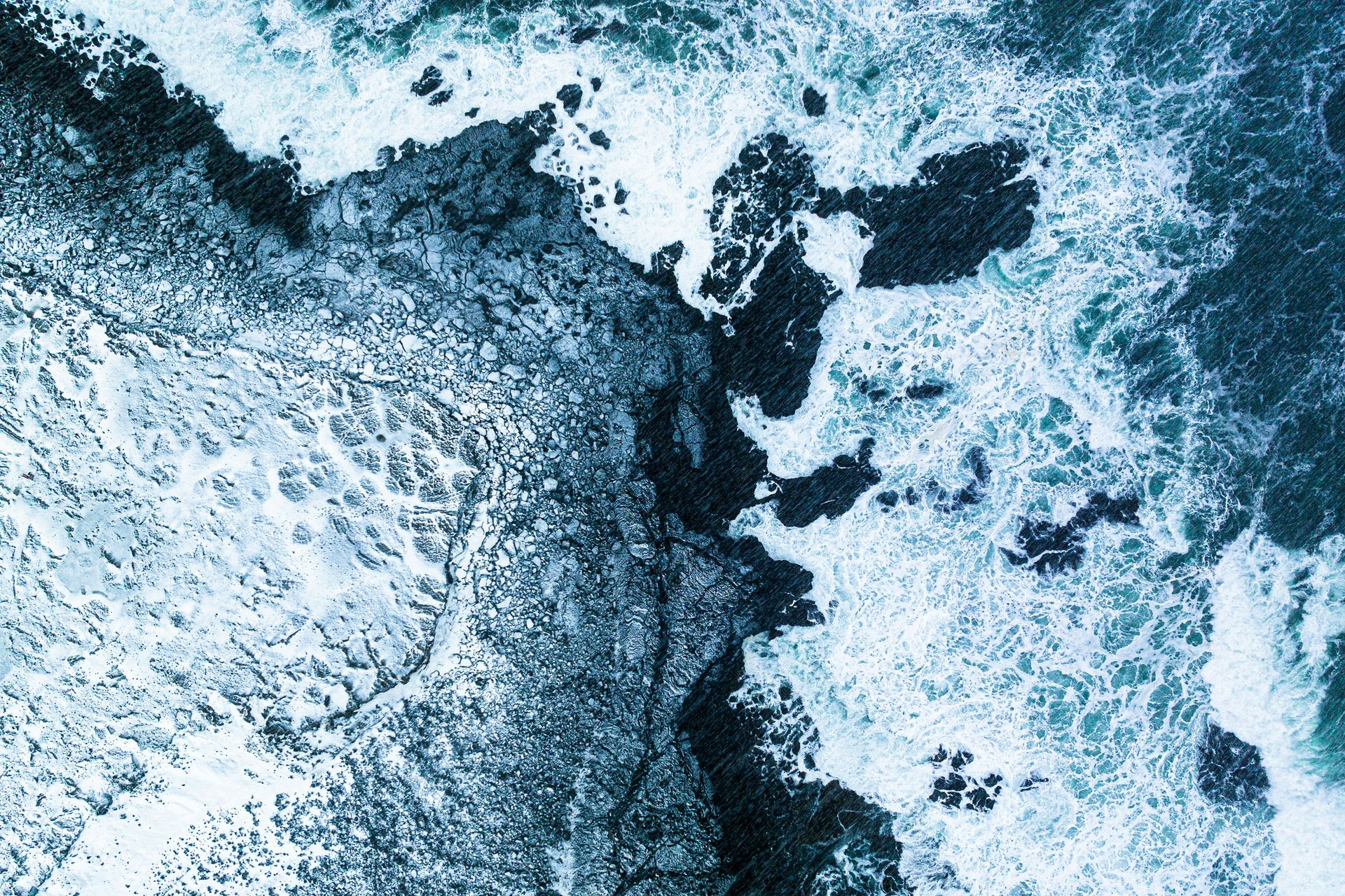 Atlantic waves washing over the rocky shoreline at Valahnúkamöl