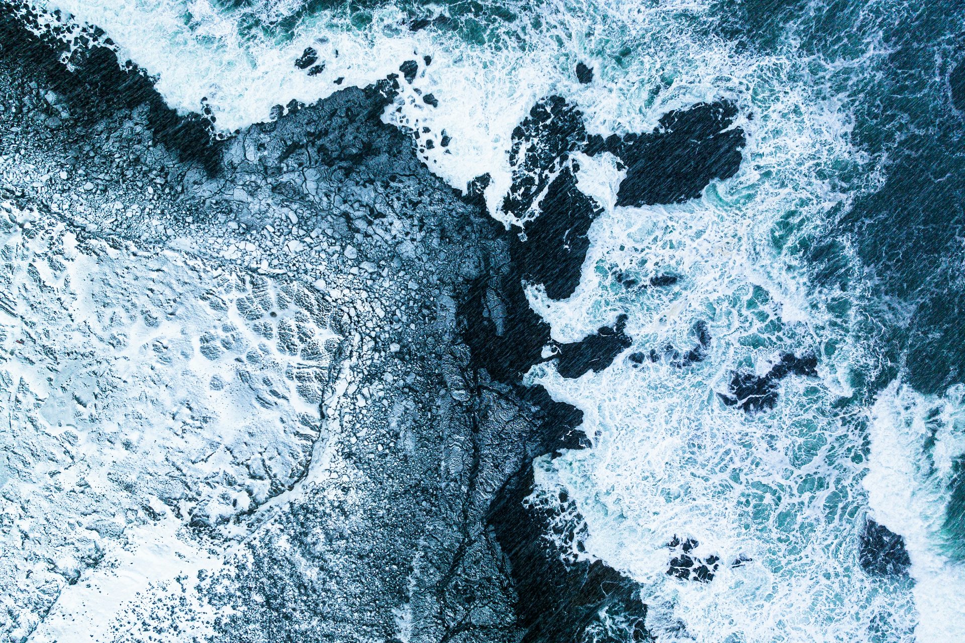 Atlantic waves washing over the rocky shoreline at Valahnúkamöl