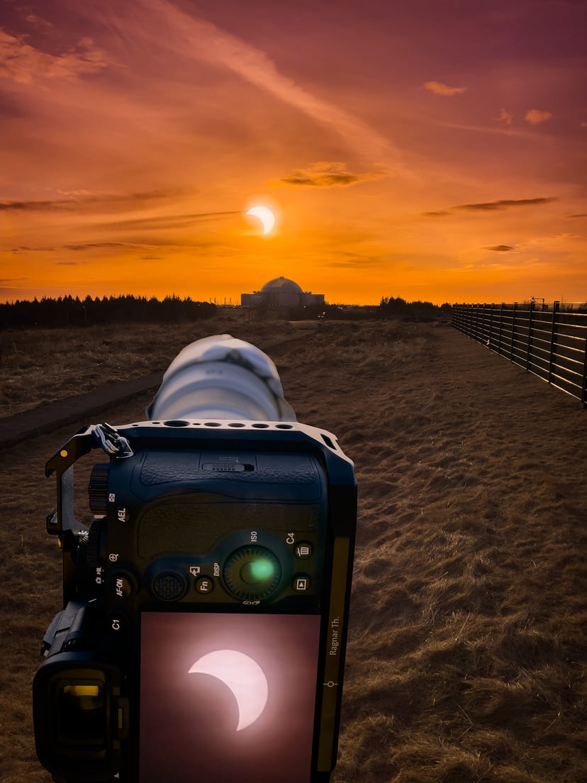 A camera taking a photo of the solar eclipse