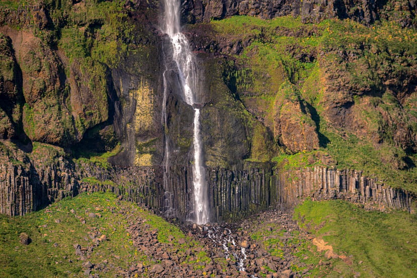 basalt columns with water falling over them
