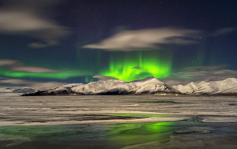 Hoffellsjökull Glacier during winter with green northern lights in the sky