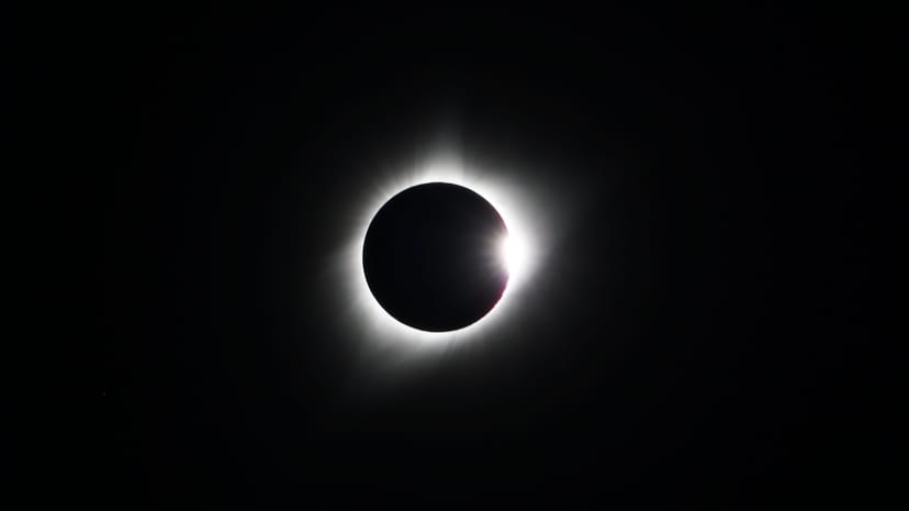 total solar eclipse with a white glow on a black background